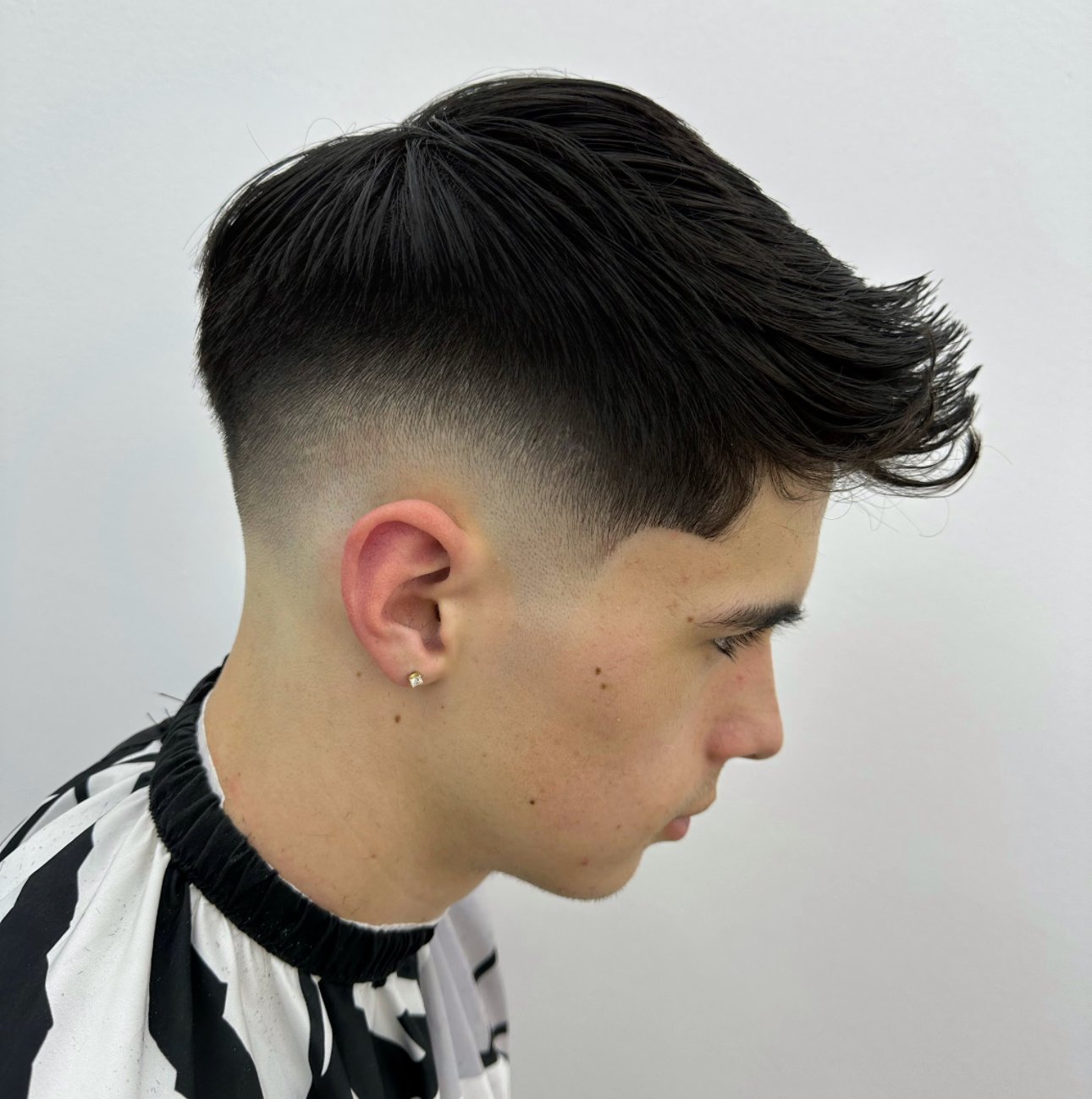 Skin fade with styled top by PN Barbershop